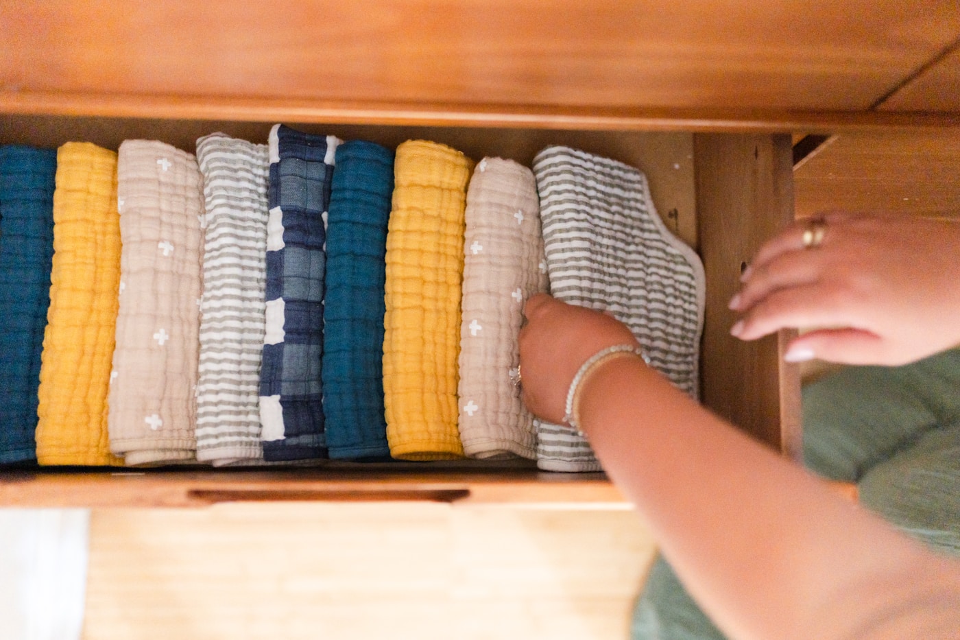 Neatly folded clothes in a wooden drawer